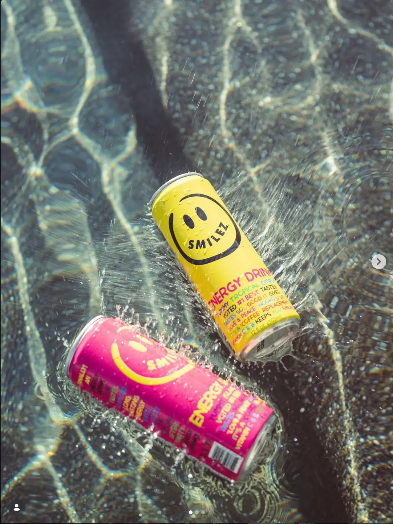 Beverage cans photographed in sunlit water